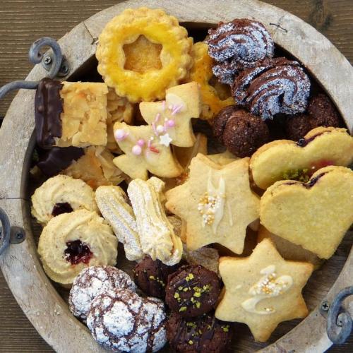 a plate filled with cookies cut in festive shapes.